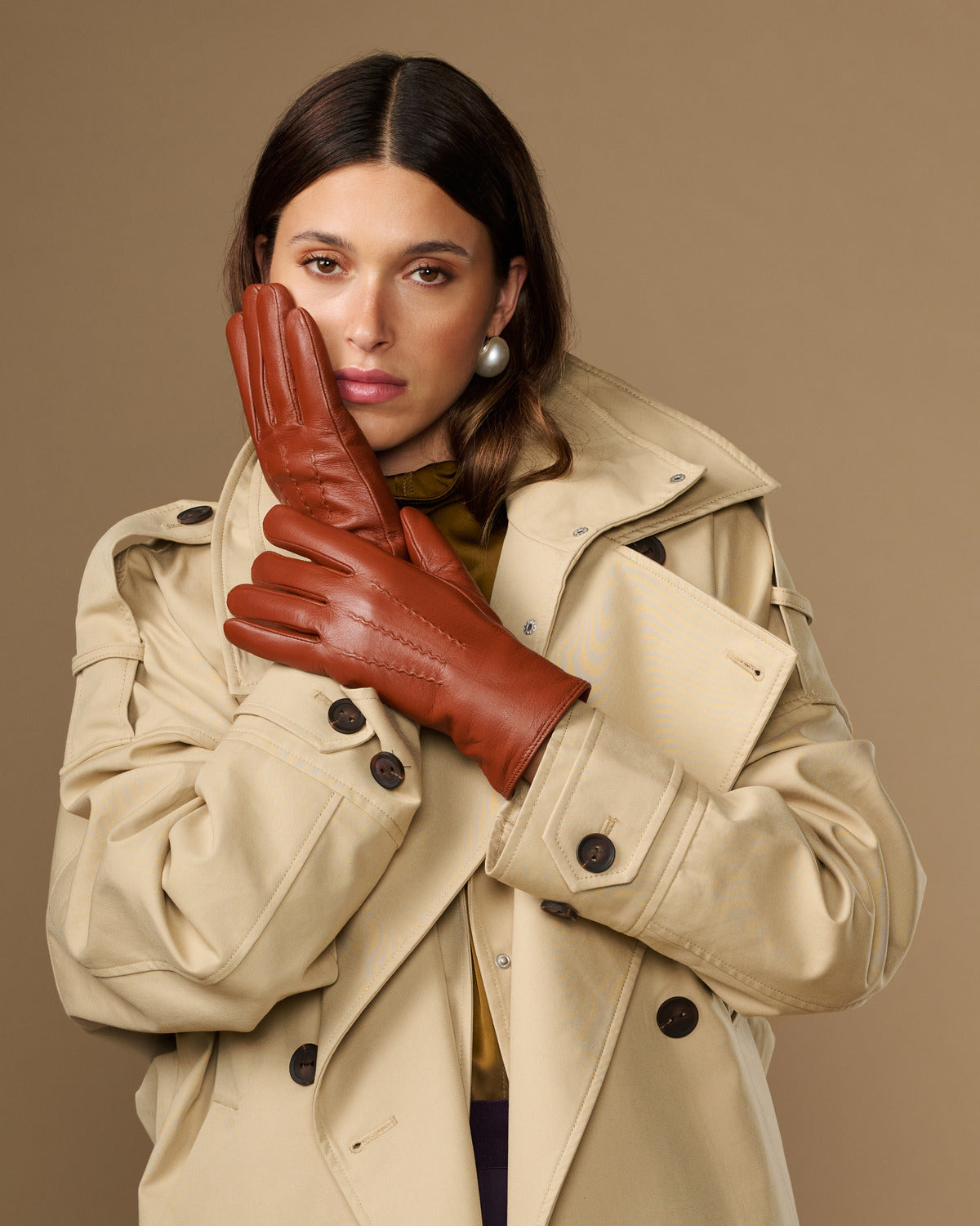 Cognac brown goatskin leather gloves with clean seams and five-finger design