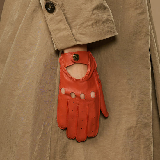 Women's orange lambskin driving gloves, touchscreen thumb cutout and snap cuff