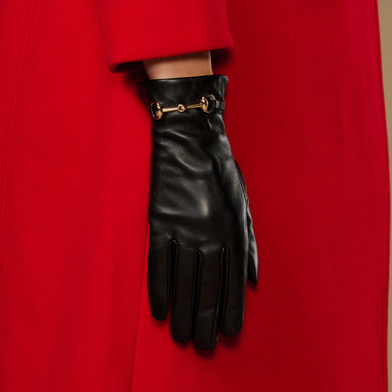 Black leather gloves with gold-tone buckle on wrist and fingerless design