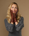 Extra-long cognac leather gloves with plush cuff and small crest at the wrist