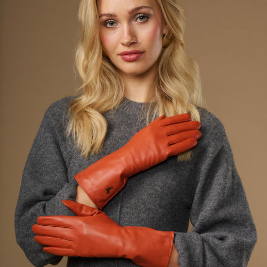 Orange leather gloves with long cuffs and stitched fingertips, cashmere-lined look