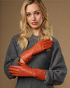 Orange leather gloves with long cuffs and stitched fingertips, cashmere-lined look