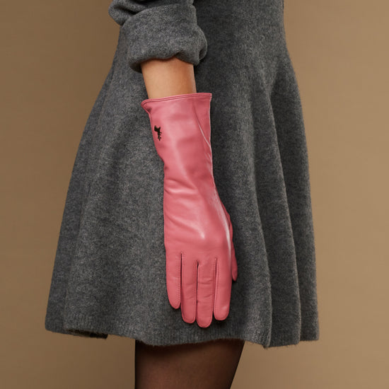 Pink leather glove with long cuff reaching past the wrist and finger seams