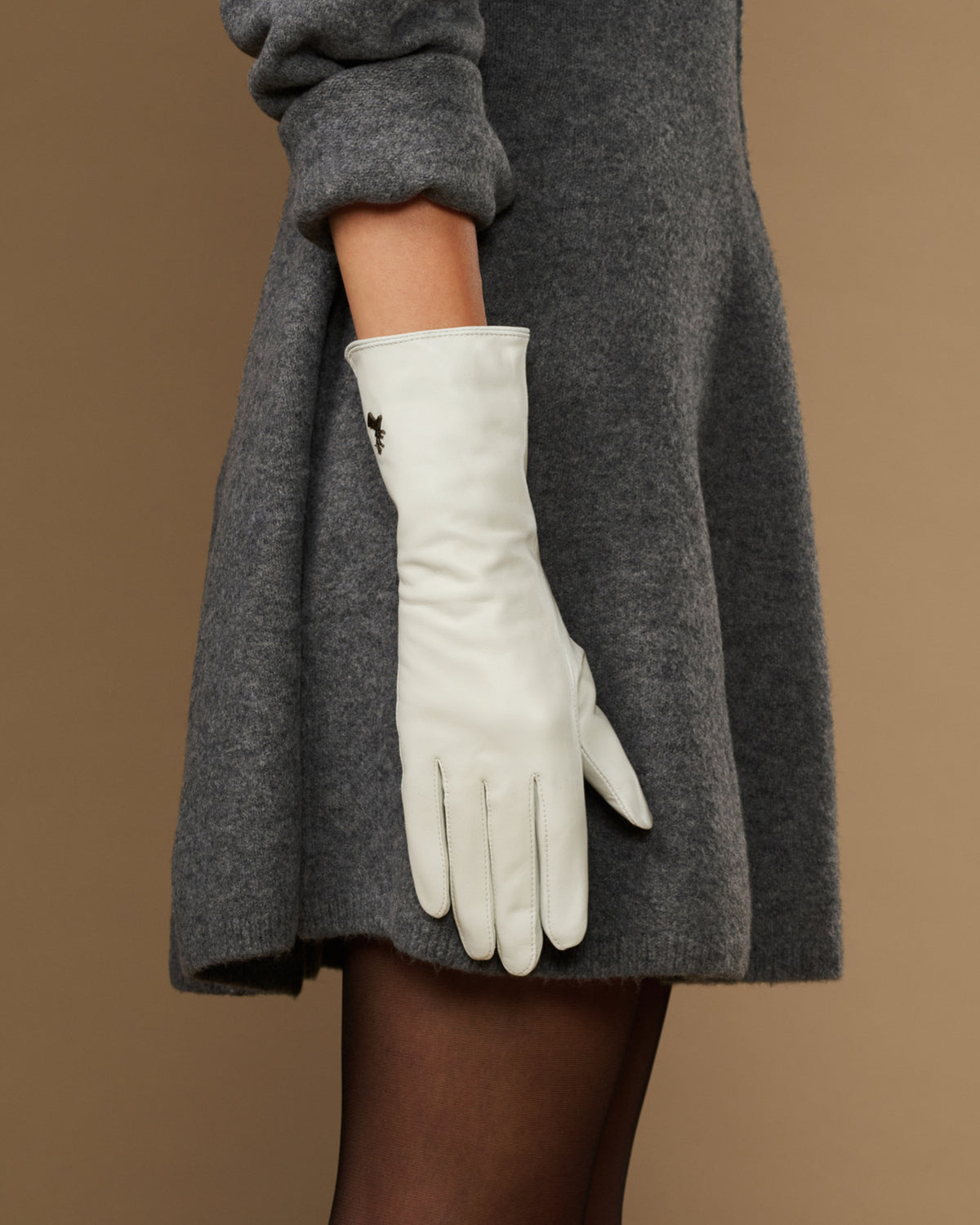 White long leather gloves, full hand view with subtle logo on cuff