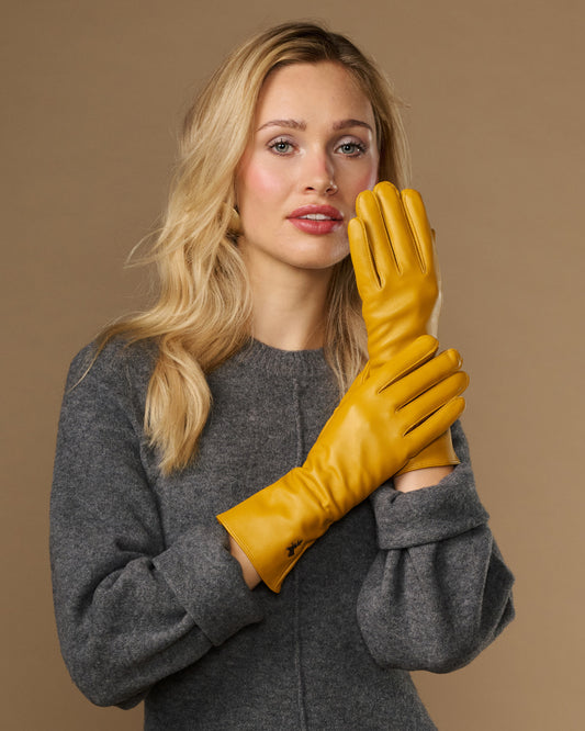 Yellow extra-long leather gloves with cashmere lining; touchscreen fingertips; cuff logo detail