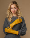Yellow extra-long leather gloves with cashmere lining; cuff logo and touchscreen fingertips visible