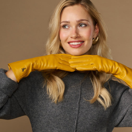 Yellow extra-long leather gloves with cashmere lining; cuff logo and touchscreen fingertip area