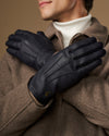 Men's navy leather gloves with wool lining, gold logo on palm and diagonal seam