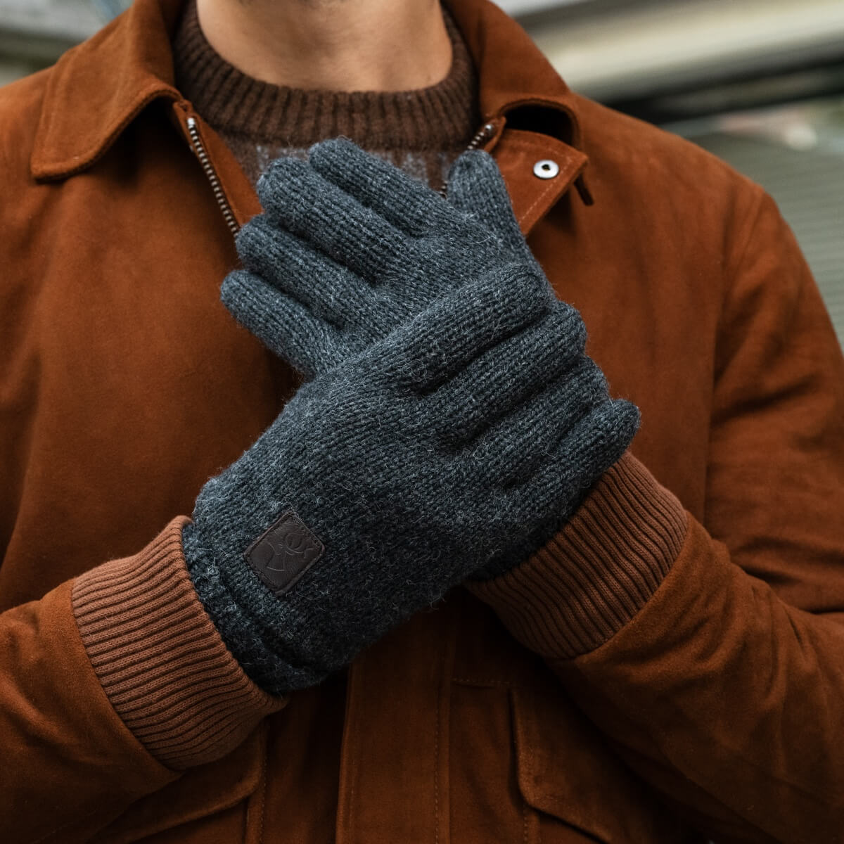 Dark grey knitted gloves, fleece-lined interior visible at cuff and thumb