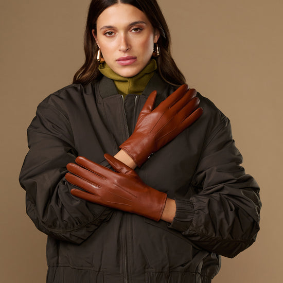 Women’s cognac leather gloves with fur-lined cuffs and snug wrist fit