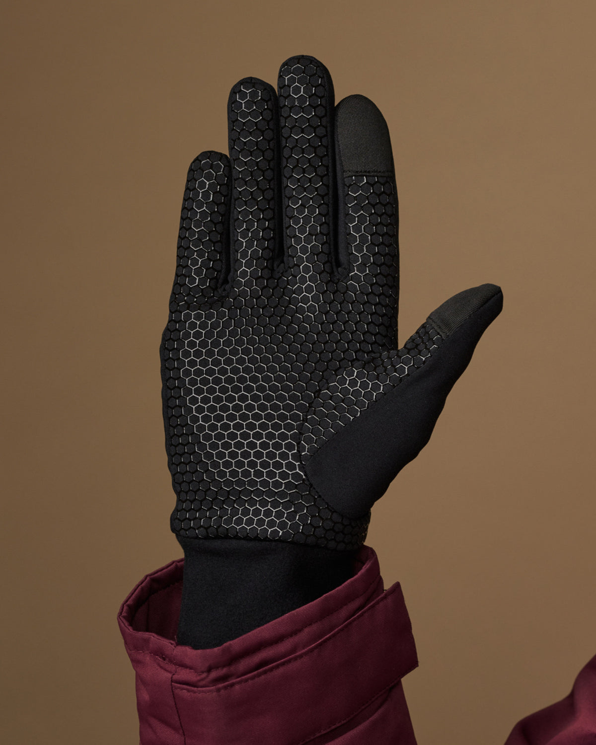Black activity glove with a textured grip palm and reinforced fingertips