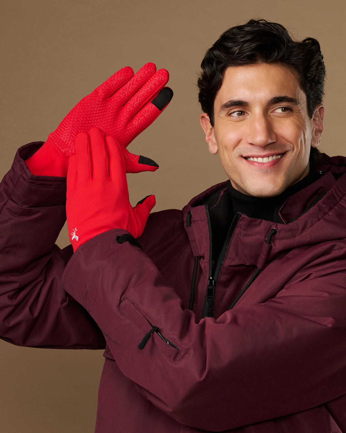 Red activity gloves with textured palms and black fingertips, worn by a model
