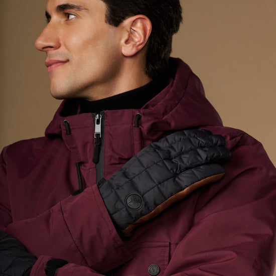 Men's quilted touchscreen glove on hand, dark gray with brown lining