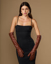 Women's chocolate brown elbow-length leather gloves worn with black dress