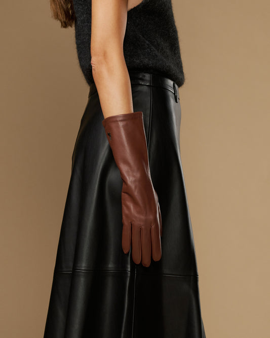 Brown mid-forearm leather glove pair with extended cuffs, side view