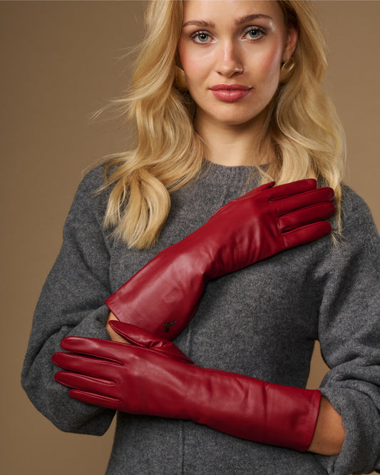 Red lambskin leather mid-forearm gloves with smooth cuffs and stitched fingers