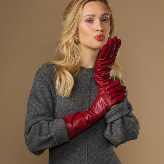 Red lambskin leather mid-forearm gloves with snug fit and smooth cuff finish