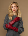 Red leather mid-forearm gloves with stitched fingertips and streamlined cuff seams