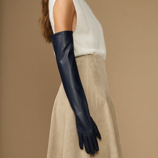 Navy leather opera gloves with long cuffs and silk lining, side view on the arm