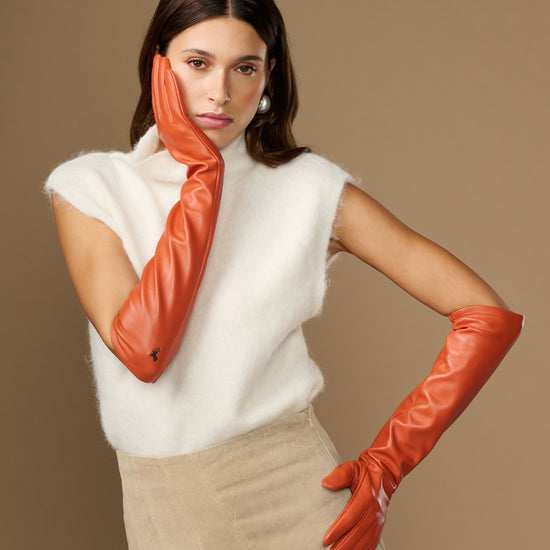 Women’s orange leather elbow gloves, smooth finish, covering hands to mid-forearm
