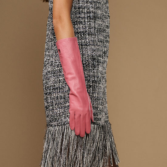 Pink below-elbow leather glove pair, fitted fingers and cuffs, hand held down