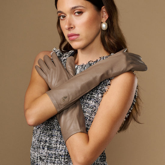 Taupe lambskin leather gloves, below-elbow length, smooth stitched fingers and slim cuff.