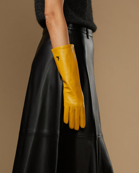 Yellow leather glove with mid-forearm cuff and clean, stitched finger detailing