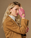 Pink fingerless lambskin driving gloves, side view with open fingers and snaps