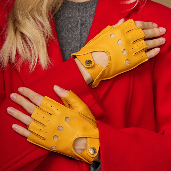 Yellow fingerless leather driving gloves with perforated knuckle detail and thumb opening