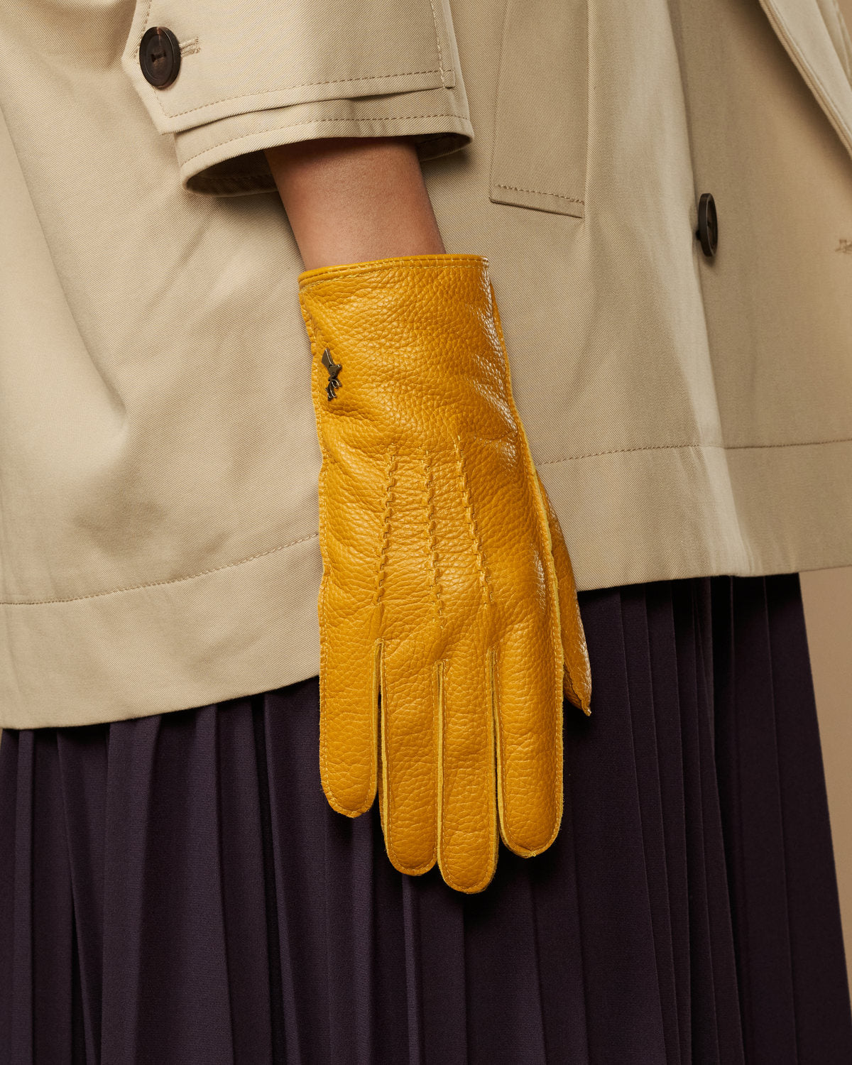 Yellow deerskin leather glove with vertical stitch detail and fitted wrist cuff